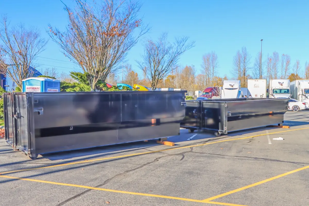 Professional dumpster rental service with roll-off container on residential driveway in Johnson City